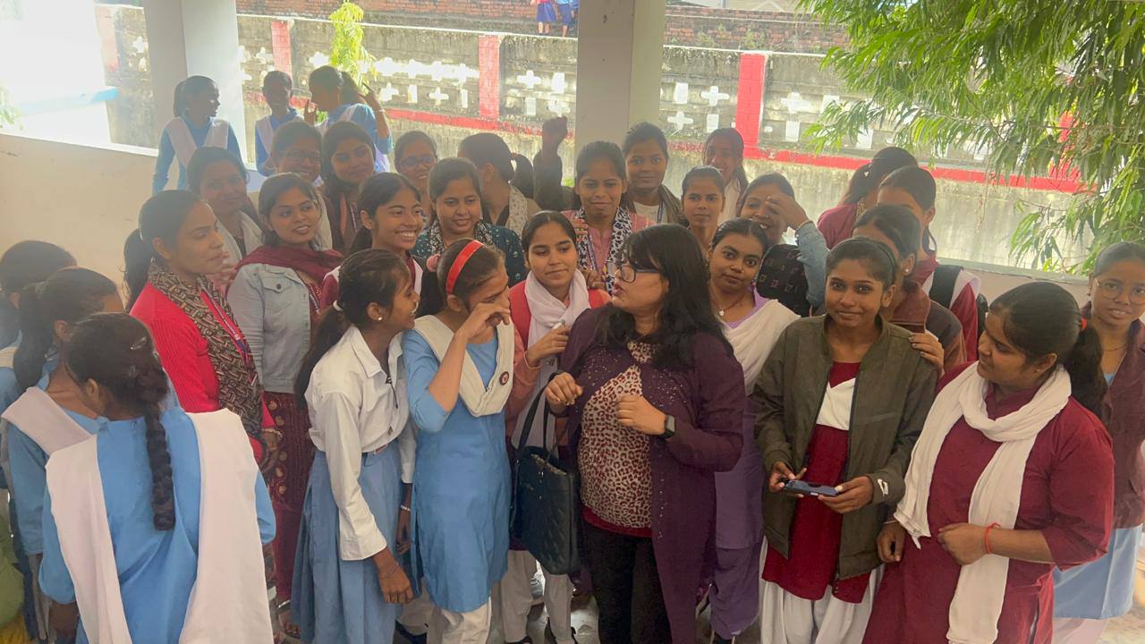 Sunita surrounded by school students after a session